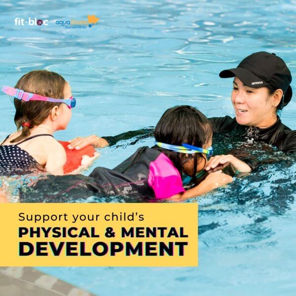 Coach with two kids during swimming classes